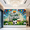 A vibrant football themed birthday backdrop banner featuring a crown, balloons, and soccer balls on a green field.