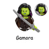 A figurine of Gamora from Marvel, featuring green skin and black hair, holding a sword.