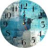 A round blue and gray wall clock with black Roman numerals and a gold-tipped hand showing the time.