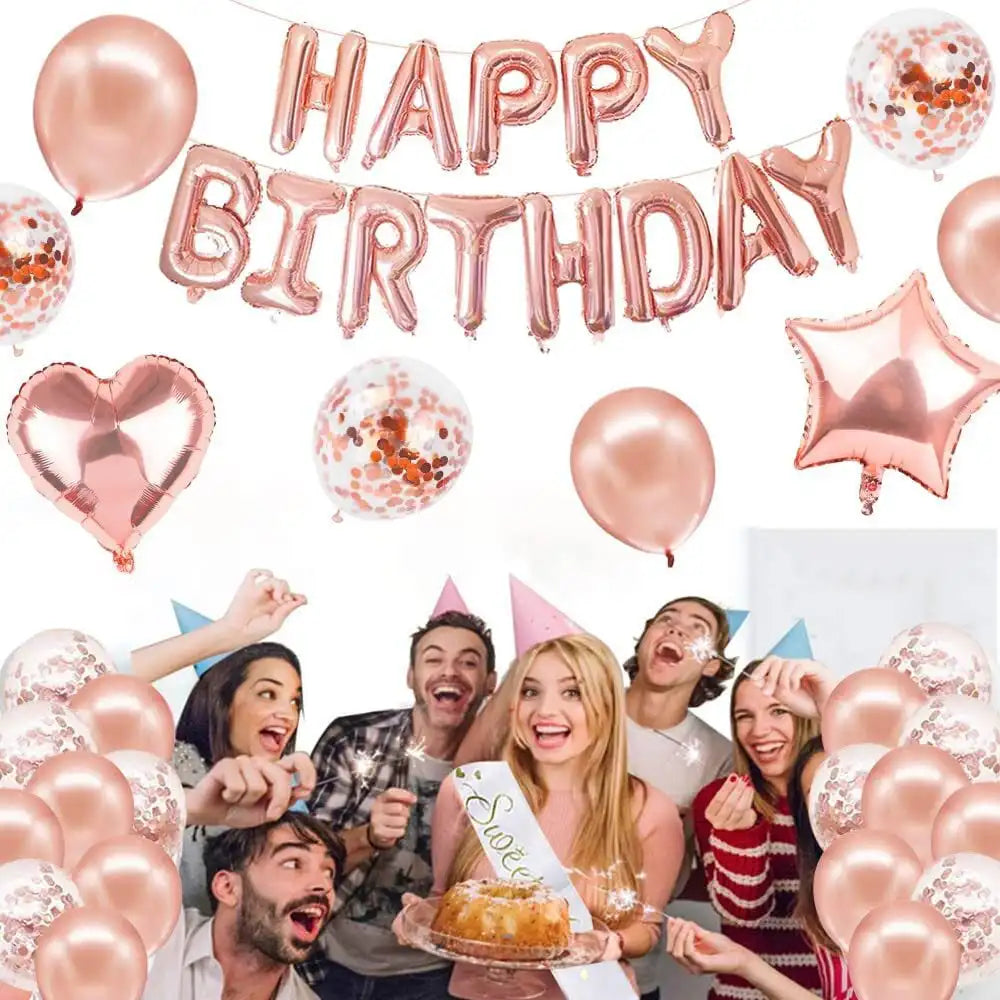 A photo of a birthday celebration setup featuring a rose gold balloon garland with confetti, stars, and hearts.
