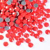 A pile of red and silver glass rhinestones in mixed sizes.