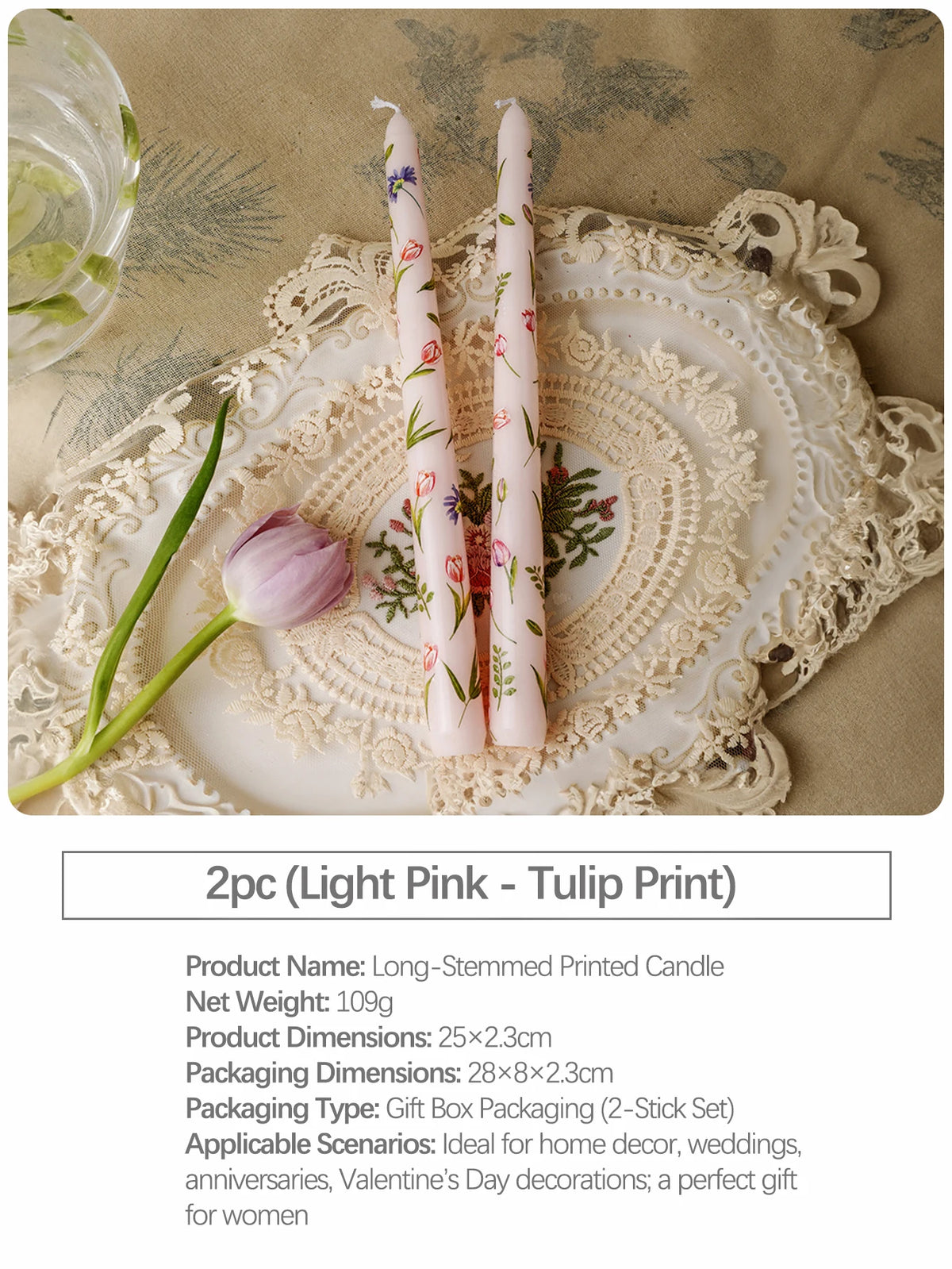 Two long-stemmed printed candles in light pink and green floral patterns displayed on a lace plate.