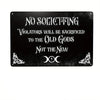 A black metal tin sign with white text that reads No Soliciting Violators Will Be Sacrificed to the Old Gods Not the New with