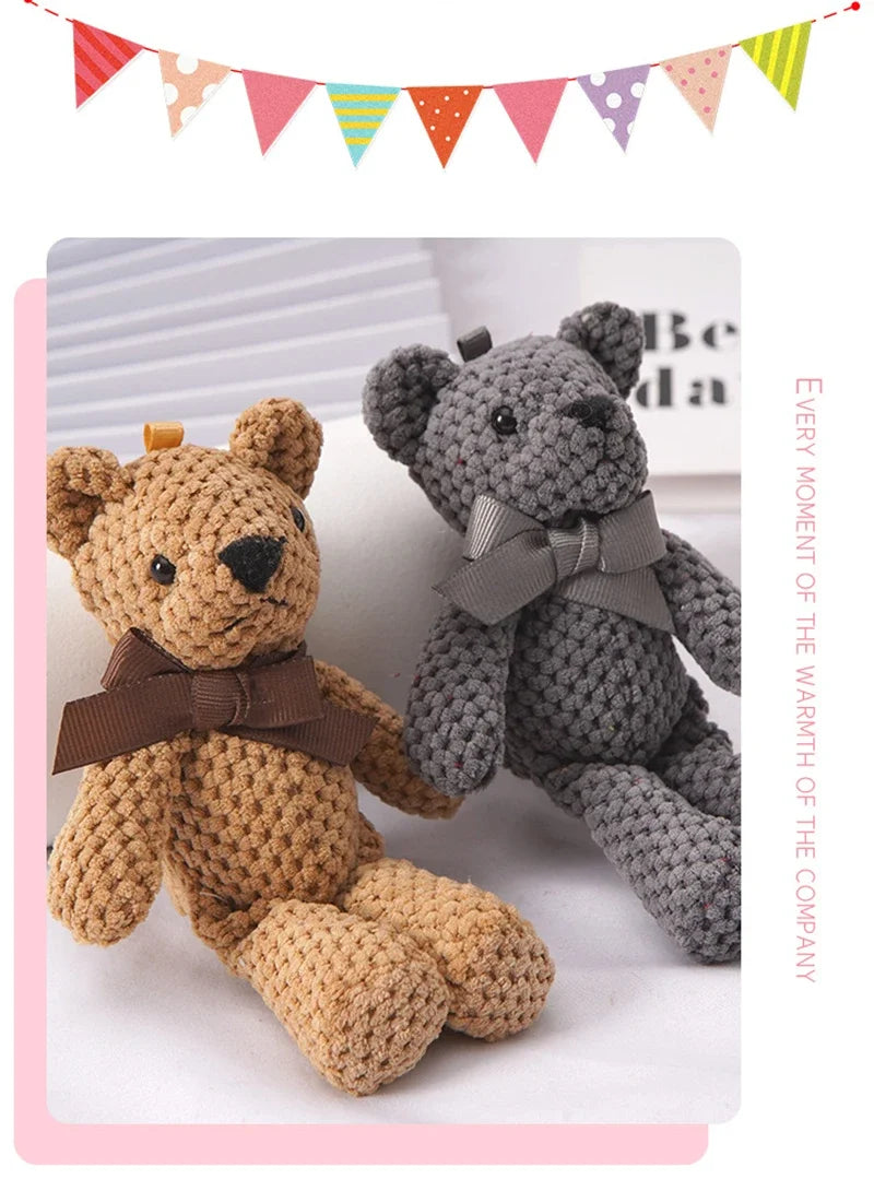 A brown crocheted stuffed bear toy next to a gray crocheted stuffed bear, displayed under a colorful pennant banner.