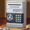 A grey password saving piggy bank for kids with a dial and keypad displaying various numerical options.