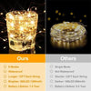 A close-up of a glass jar filled with bright fairy lights, next to a coiled string of similar lights.