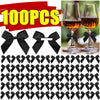 A collection of black satin ribbon bows with self-adhesive backing shown in various sizes and patterns.