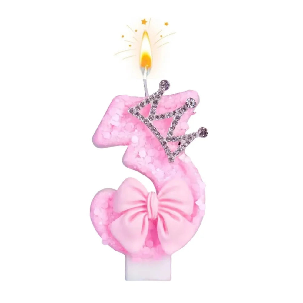 Pink bow crown number birthday candles set with a lit flame