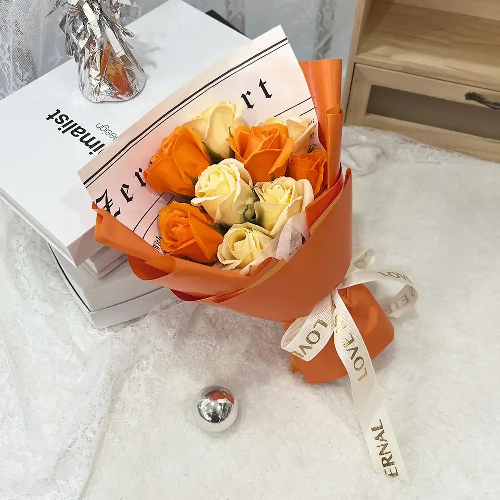 An orange and cream artificial rose flower bouquet wrapped in kraft paper and tissue paper.