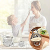 Stainless steel dumpling maker with crimped edge next to a woman and child making dumplings.