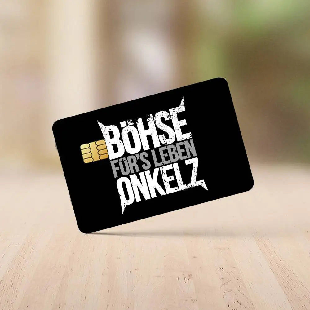 A black rectangular sticker with white text reading BÖHSE FÜR'S LEBEN ONKELZ on a light wooden surface.