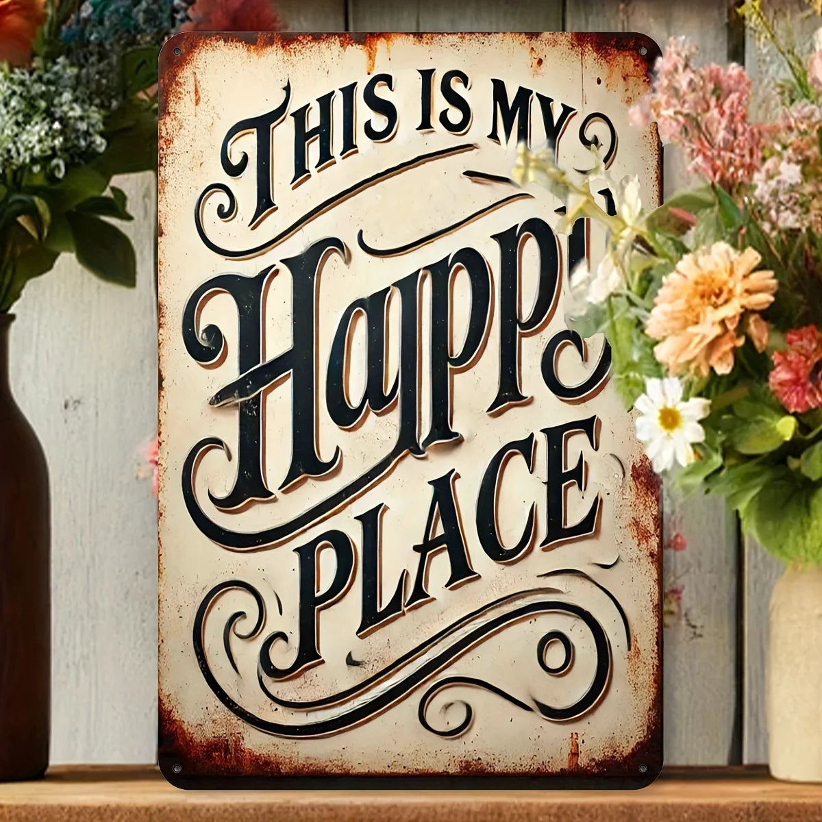 A rustic iron wall sign with carved text that reads This Is My Happy Place, displayed on a wooden shelf.