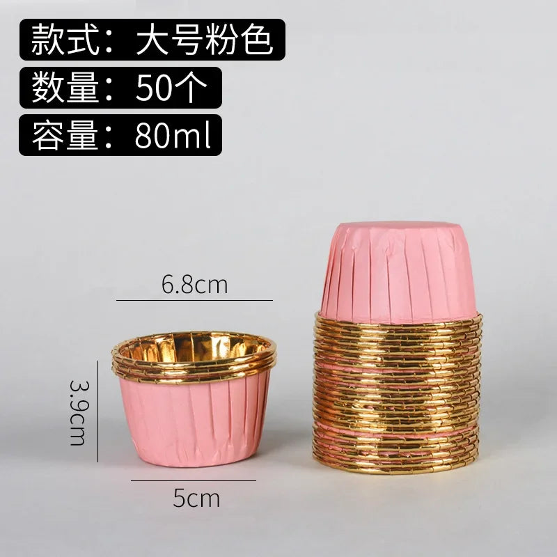 A stack of 50 golden greaseproof cupcake liners in pink and gold.