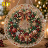 DIY Christmas wreath made of red and green glitter, pearls, and diamonds, hanging with a metal chain.