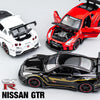 A collection of Nissan GTR diecast models in white, red, and black, showcasing various sports car scales.