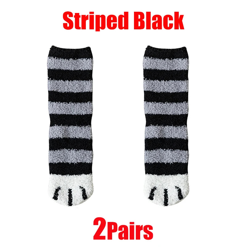 A pair of striped black and gray cat paw print plush socks.