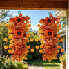 An autumn sunflower teardrop swag with maple leaves hanging on a front door.