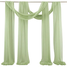Elegant sage green chiffon arch drapes used as a backdrop for weddings and events
