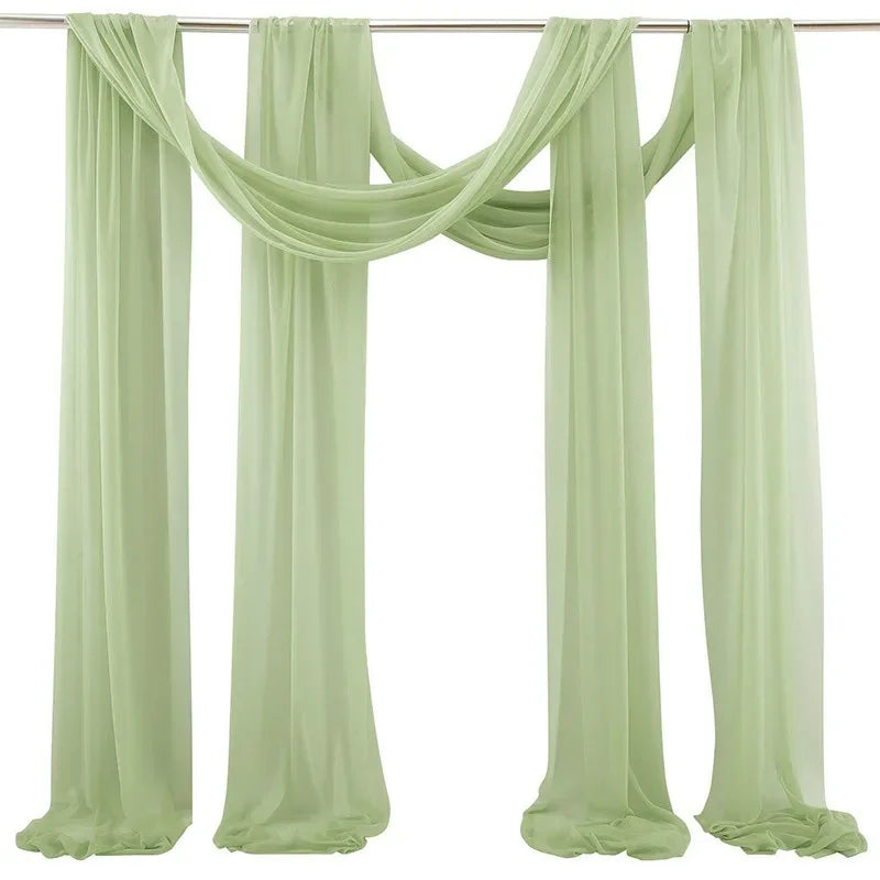Elegant sage green chiffon arch drapes used as a backdrop for weddings and events