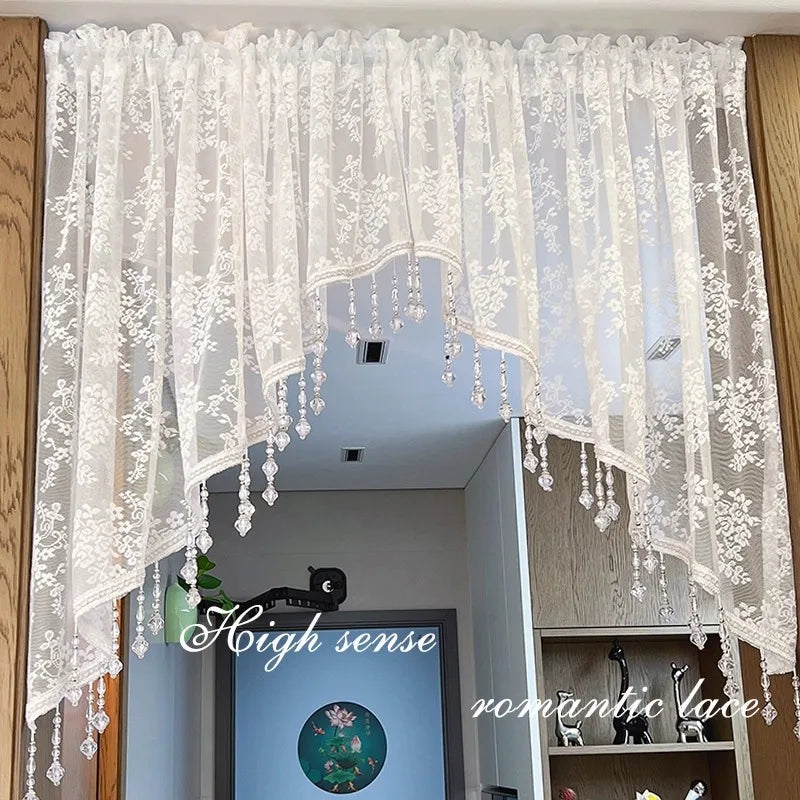 White French vintage beaded lace valance curtain hanging in a modern interior