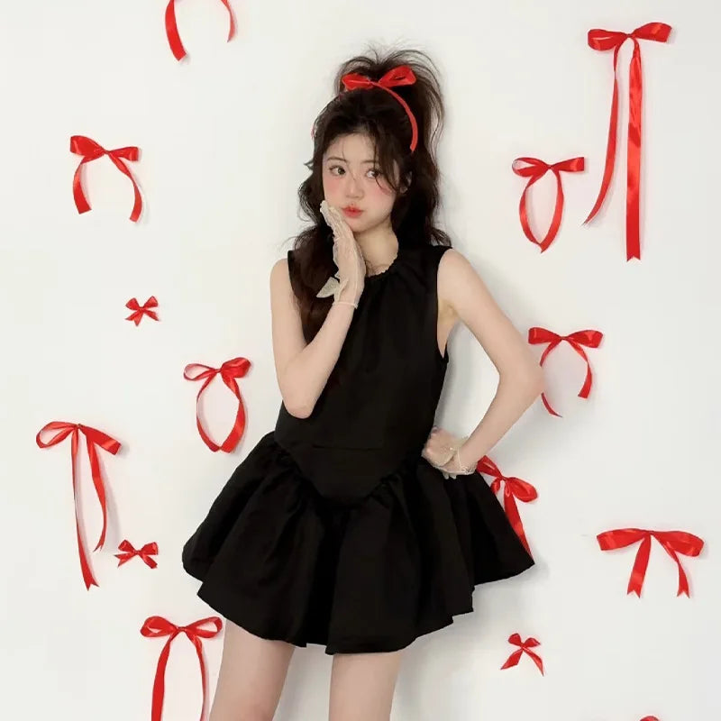 A woman wearing a black dress is posing against a white background surrounded by red bowknot ribbons.