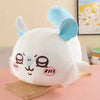 A white Chiikawa Hachiware plush pillow with blue ears and cute facial features resting on a wooden surface.