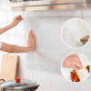 Hands are applying clear oil-proof self-adhesive film to a tiled wall surface.