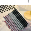 A hand holds a stack of portable folding HD makeup mirrors with various colored frames.