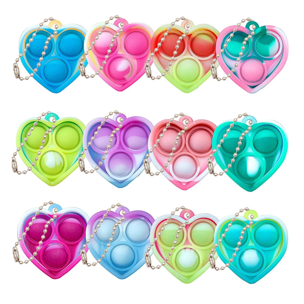 A set of colorful mini sensory fidget keychains shaped like hearts, featuring various pastel colors.