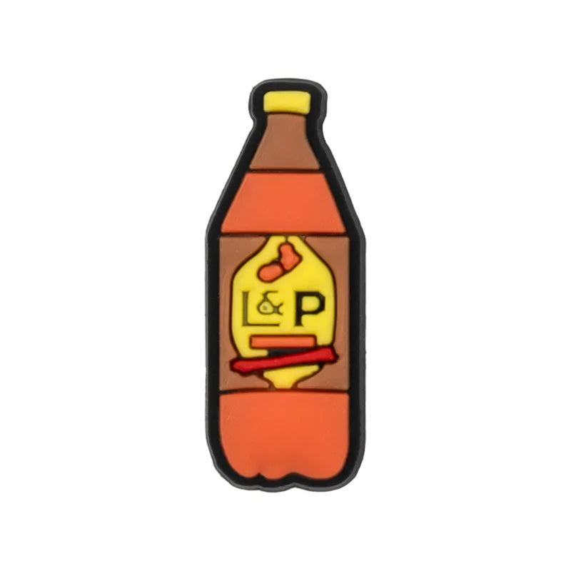 A black and orange PVC shoe charm shaped like a bottle with a yellow label featuring the letters L&P