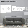 A chart showing various sizes of wall displays in inches and centimeters displayed above a gray sofa.