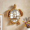 Golden sea turtle resin wall decor mirror with textured gold frame hanging on a beige wall.