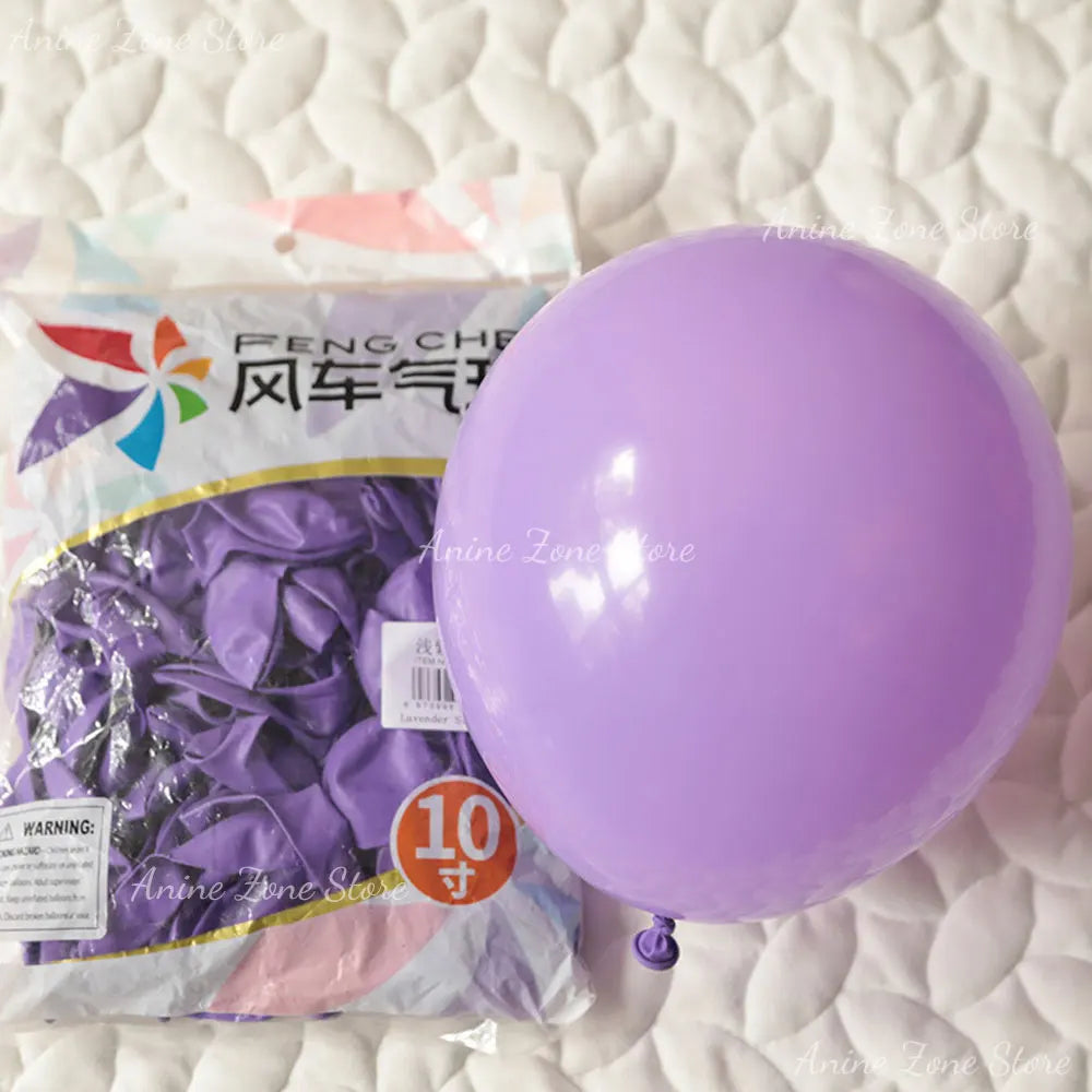 A purple latex balloon is shown next to a package of pastel pink balloons for party decorations.