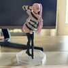 Anime-style girl figurine with pink hair wearing a striped sweater and black boots.