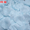 Light blue silk rose petals scattered on a surface for weddings and events
