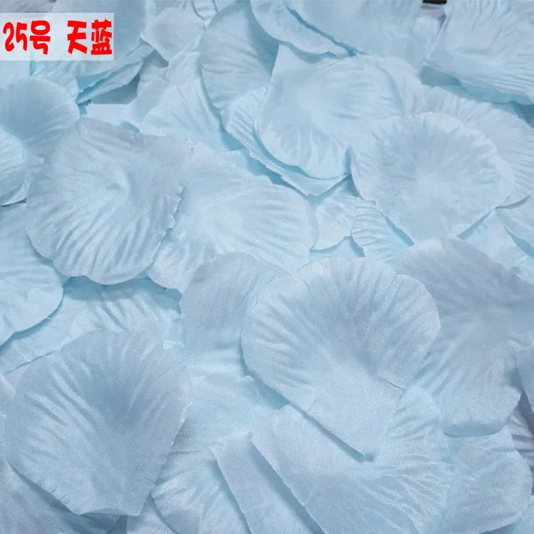 Light blue silk rose petals scattered on a surface for weddings and events
