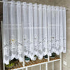 White lace mesh sheer curtains hanging on a rod, featuring floral embroidery and a rod pocket.