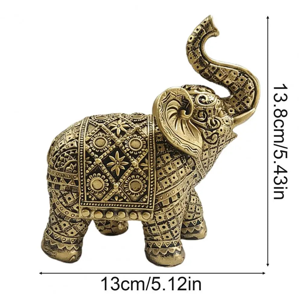 Gold-colored resin elephant sculpture with decorative patterns and trunk, shown in profile.