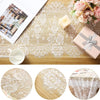 White embroidered lace table runner with floral patterns on a wooden surface.