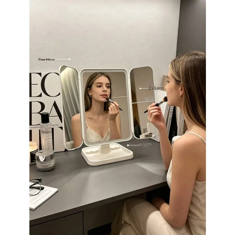 A woman is using a tri-fold LED makeup mirror with dimmable lighting for applying makeup.