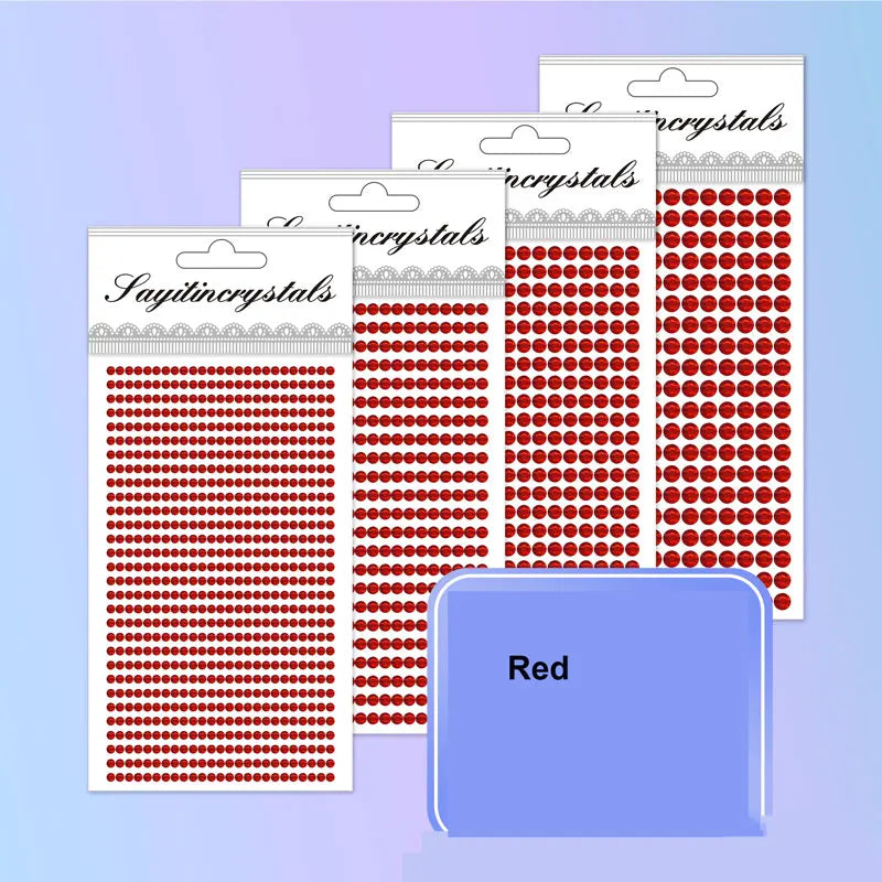 A collection of red self-adhesive rhinestone embellishments packaged in clear plastic sheets.