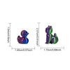 A small, iridescent purple and green cat figurine for desk or shelf decor.