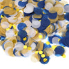 A pile of round tissue paper confetti dots in shades of blue, gold, and white.
