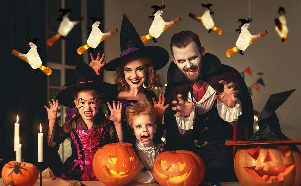 A family of four celebrating Halloween with floating LED candles and a magic wand remote