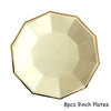Eight 9-inch gold disposable plates arranged in a star pattern.