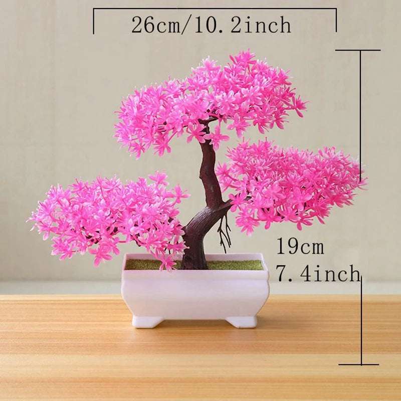 A pink artificial tree bonsai decoration with vibrant blossoms planted in a white rectangular pot.