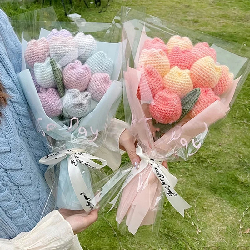 A bouquet of handmade crochet tulips in shades of pink and peach, wrapped in clear cellophane.