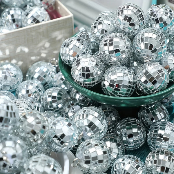 A pile of silver and clear mini disco ball ornaments in various sizes and shapes.