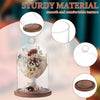 A glass dome cloche with a wooden base displaying floral arrangements for decoration.