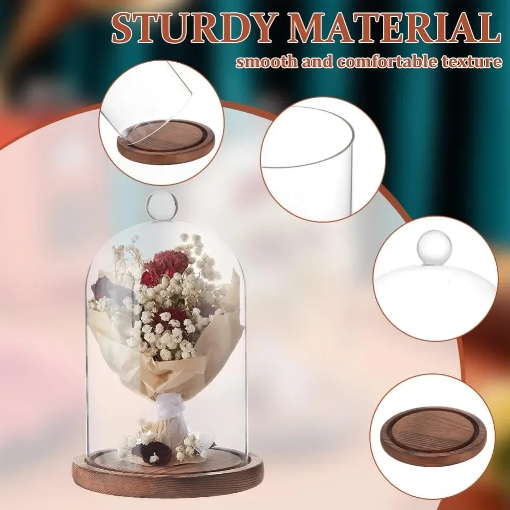 A glass dome cloche with a wooden base displaying floral arrangements for decoration.
